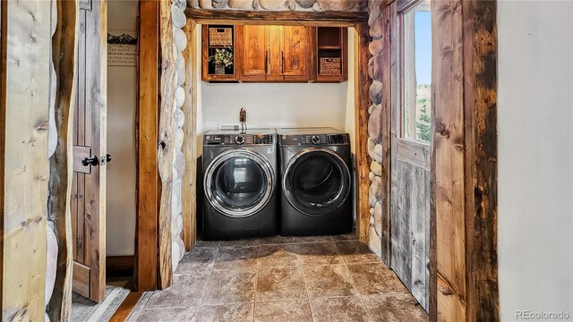 700 Cottage Grove Rd, Alma, CO 80420 - washroom featuring washer and clothes dryer, cabinet space, plenty of natural light, and stone finish floors
