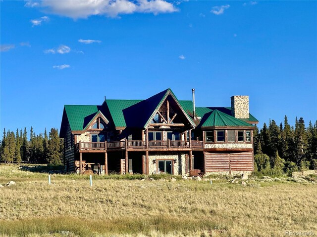 700 Cottage Grove Rd, Alma, CO 80420 - rear view of house featuring a chimney, metal roof, and a wooden deck
