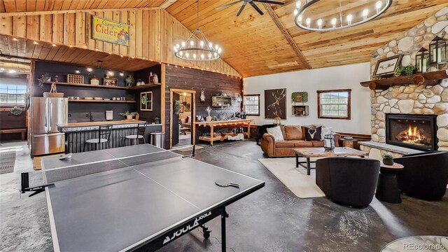 700 Cottage Grove Rd, Alma, CO 80420 - playroom with a chandelier, wood ceiling, concrete flooring, high vaulted ceiling, and a stone fireplace