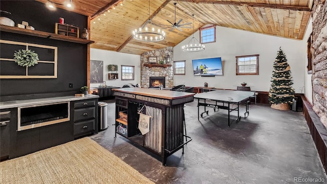 700 Cottage Grove Rd, Alma, CO 80420 - recreation room with wood ceiling, a stone fireplace, high vaulted ceiling, a chandelier, and plenty of natural light