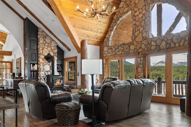 700 Cottage Grove Rd, Alma, CO 80420 - living room with a wood stove, a chandelier, beam ceiling, dark wood finished floors, and high vaulted ceiling