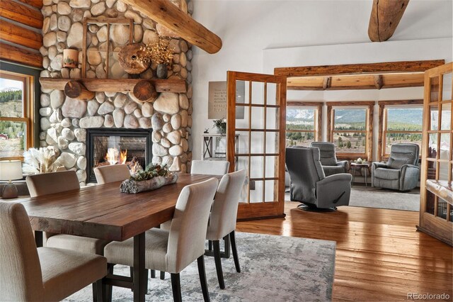 700 Cottage Grove Rd, Alma, CO 80420 - dining room featuring plenty of natural light, wood finished floors, a fireplace, and beam ceiling