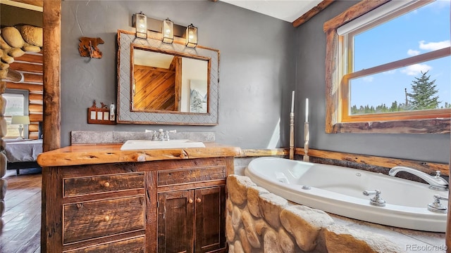 700 Cottage Grove Rd, Alma, CO 80420 - full bath featuring vanity, a garden tub, and wood finished floors