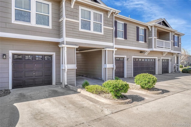 view of property with a garage and driveway
