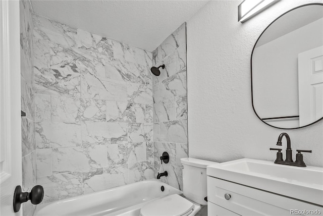 full bathroom featuring vanity, tiled shower / bath combo, a textured ceiling, and toilet