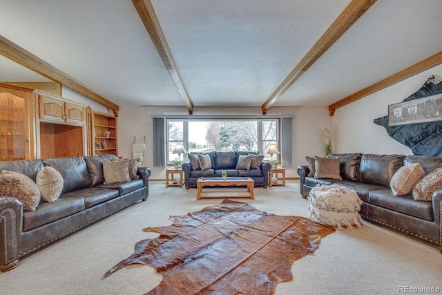 living room with carpet flooring, beam ceiling, and a textured ceiling