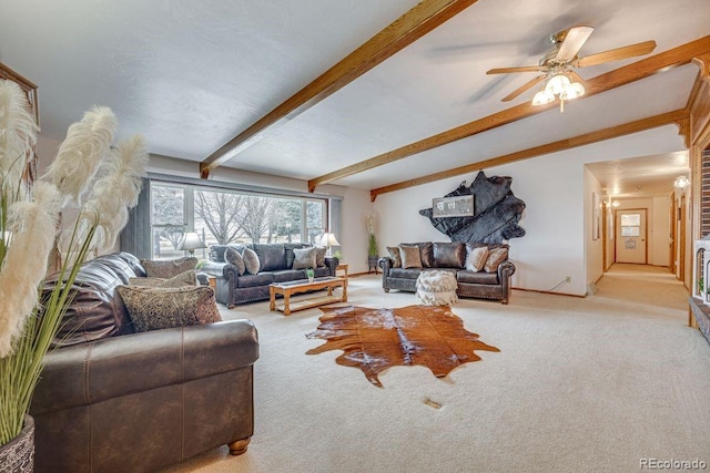 living room featuring ceiling fan, light colored carpet, and vaulted ceiling with beams