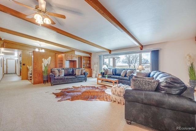 carpeted living room with beamed ceiling and ceiling fan