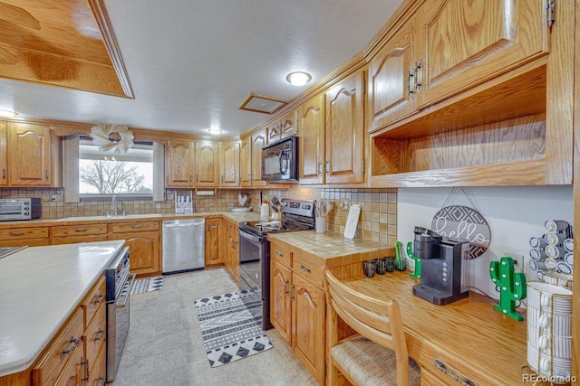 kitchen with appliances with stainless steel finishes, sink, and backsplash