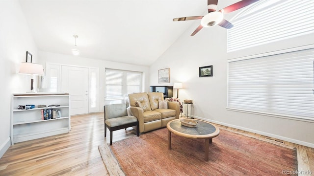 living room with high vaulted ceiling, light hardwood / wood-style floors, and ceiling fan