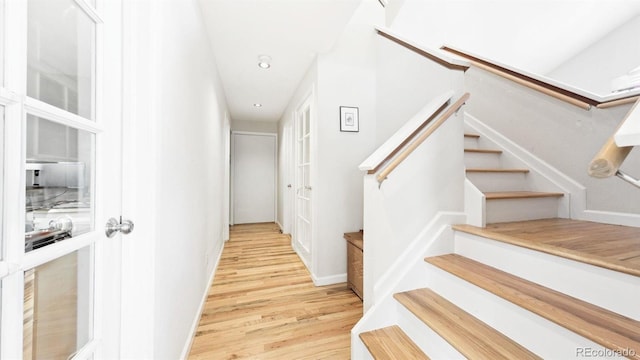 stairs featuring hardwood / wood-style flooring