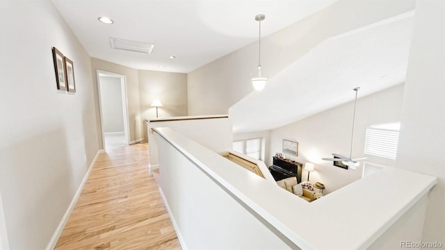 corridor with light hardwood / wood-style floors