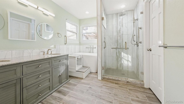 bathroom with vanity and separate shower and tub