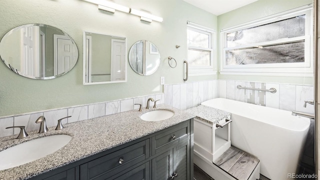 bathroom featuring vanity and a tub