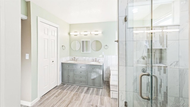 bathroom with vanity, tile walls, and an enclosed shower