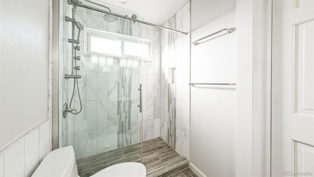 bathroom with walk in shower and toilet