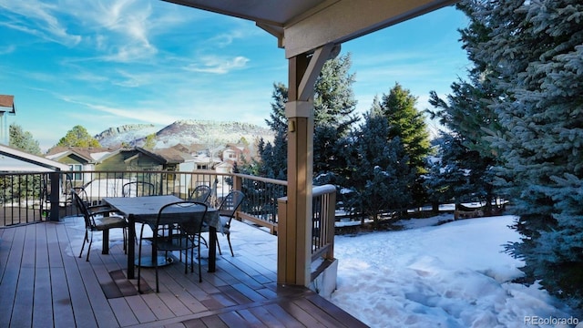 snow covered deck featuring a mountain view