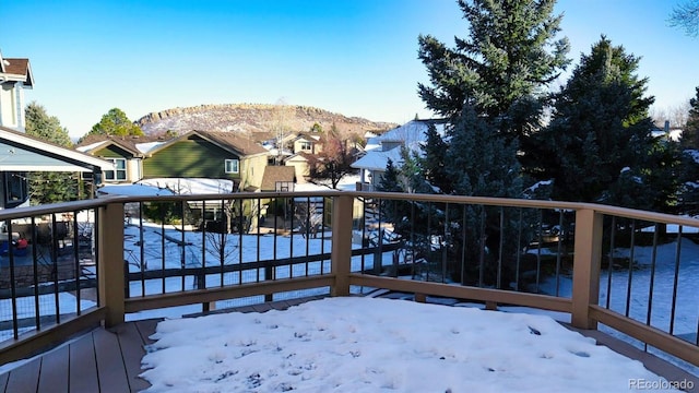 snow covered deck featuring a mountain view