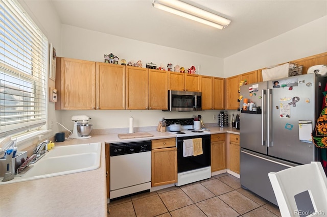 6963 Maram Way, Fountain, CO 80817 - kitchen with appliances with stainless steel finishes, light countertops, and light tile patterned floors