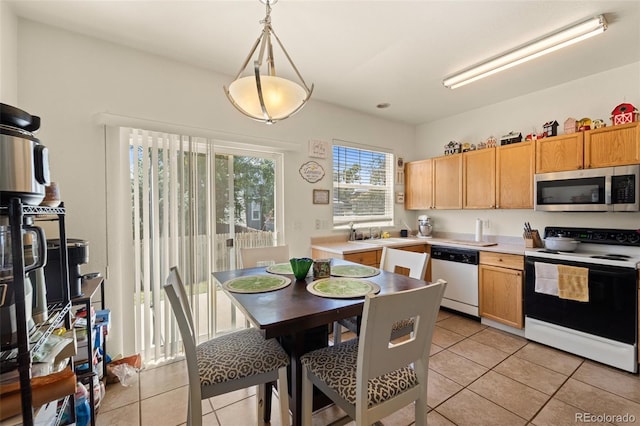 6963 Maram Way, Fountain, CO 80817 - kitchen with stainless steel microwave, range with electric cooktop, dishwashing machine, and light tile patterned floors