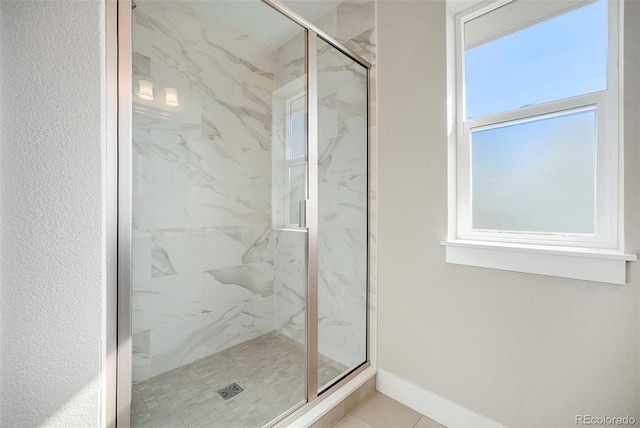 bathroom featuring tile patterned flooring and a shower with shower door