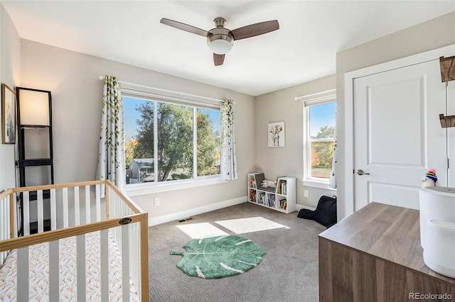 bedroom featuring light colored carpet and ceiling fan