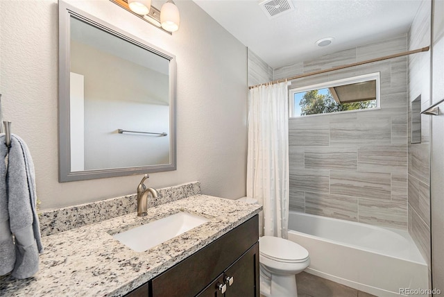 full bathroom featuring vanity, shower / tub combo, and toilet