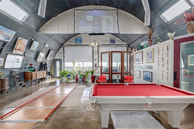 game room with pool table, concrete floors, and high vaulted ceiling