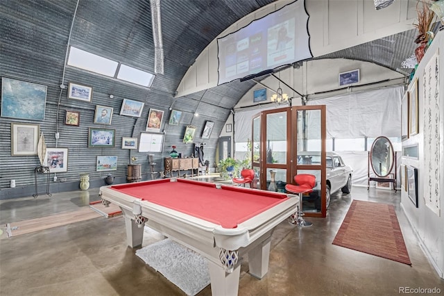 rec room with pool table, high vaulted ceiling, and concrete floors