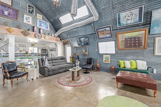 living room with high vaulted ceiling and finished concrete floors