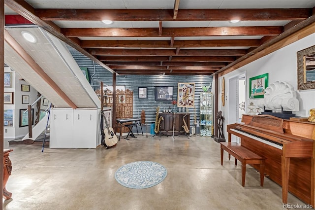 interior space featuring stairs, beam ceiling, a dry bar, and concrete flooring