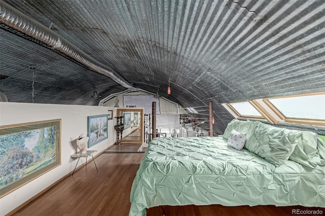 bedroom featuring lofted ceiling and wood finished floors