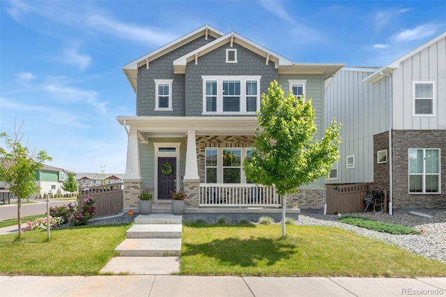 20998 E 60th Pl, Aurora, CO 80019 - craftsman inspired home with covered porch, board and batten siding, and a front lawn