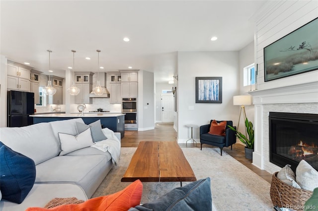 20998 E 60th Pl, Aurora, CO 80019 - living area featuring recessed lighting, light wood finished floors, and a glass covered fireplace