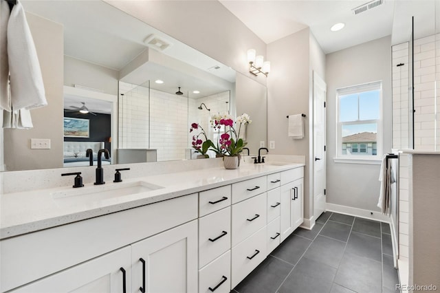 20998 E 60th Pl, Aurora, CO 80019 - bathroom with double vanity, ensuite bathroom, a tile shower, tile patterned flooring, and ceiling fan