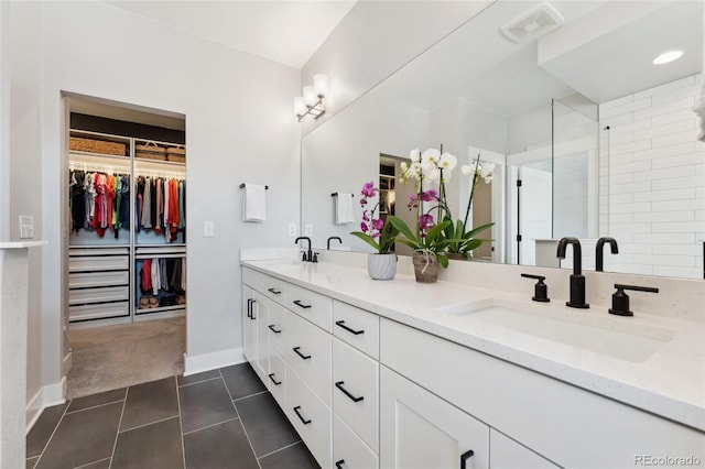 20998 E 60th Pl, Aurora, CO 80019 - full bath with double vanity, a walk in closet, tile patterned floors, and a stall shower