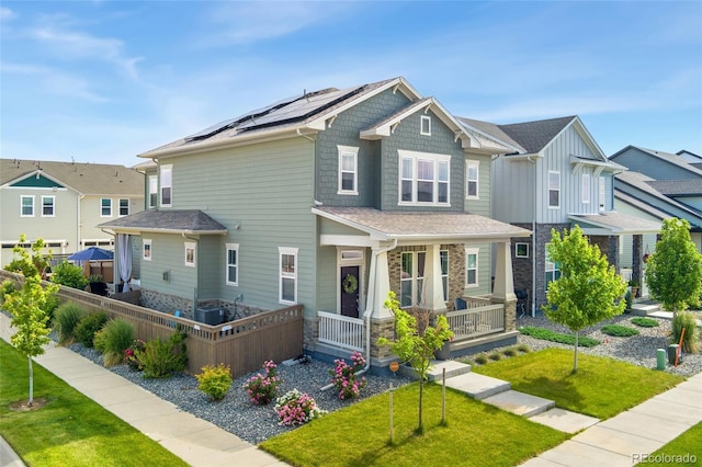 20998 E 60th Pl, Aurora, CO 80019 - craftsman house with covered porch, stone siding, roof mounted solar panels, and a residential view