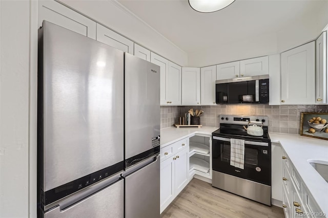 kitchen featuring light wood-style flooring, backsplash, stainless steel appliances, white cabinets, and light countertops