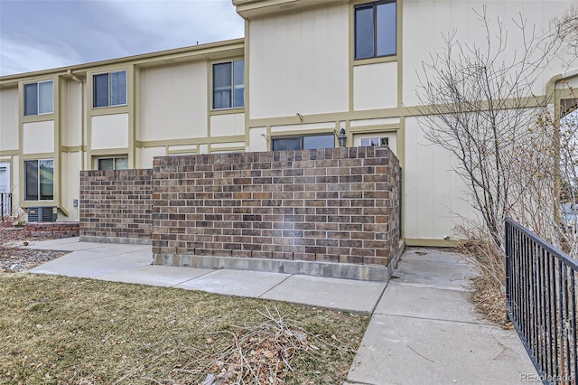 view of side of home featuring fence