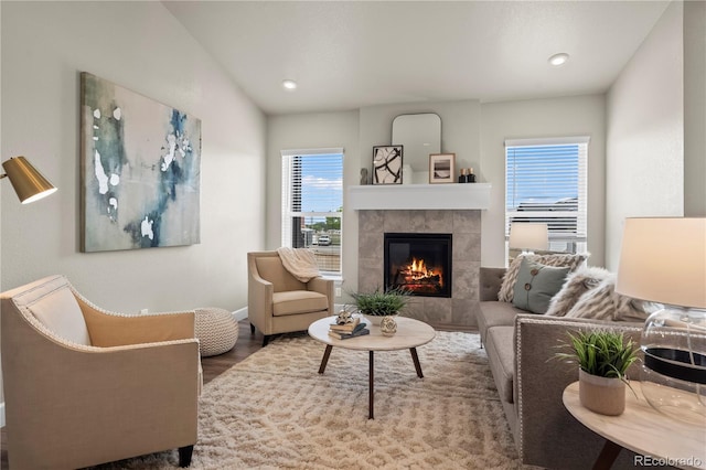 8244 S Queen St, Littleton, CO 80127 - living area featuring a tile fireplace, wood finished floors, baseboards, and recessed lighting