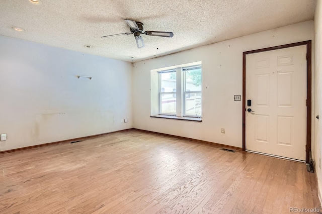 1961 Danube Way, Aurora, CO 80011 - empty room with a ceiling fan, a textured ceiling, and light wood-style floors