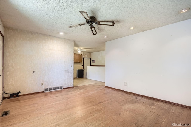 1961 Danube Way, Aurora, CO 80011 - unfurnished living room featuring a ceiling fan, light wood-style floors, a textured ceiling, and recessed lighting