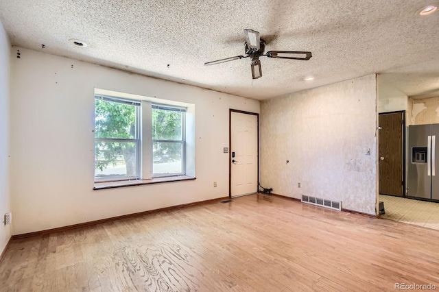 1961 Danube Way, Aurora, CO 80011 - unfurnished living room featuring a textured ceiling, ceiling fan, light wood-type flooring, and recessed lighting
