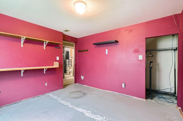 1961 Danube Way, Aurora, CO 80011 - unfurnished bedroom with unfinished concrete floors and a closet