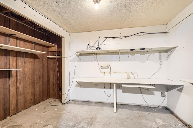 1961 Danube Way, Aurora, CO 80011 - below grade area featuring a textured ceiling and wooden walls