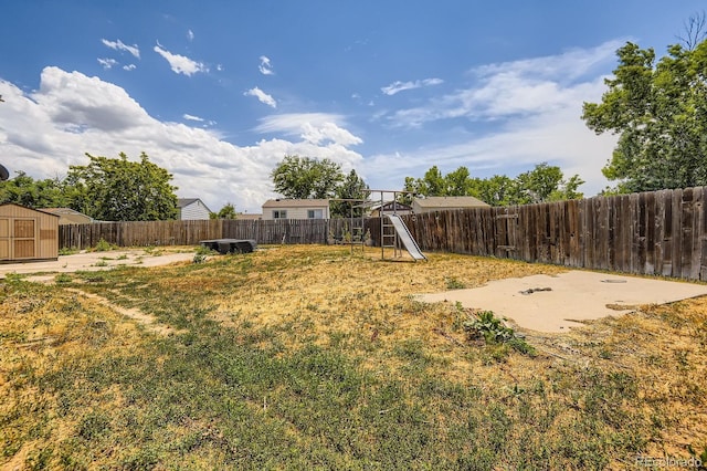 1961 Danube Way, Aurora, CO 80011 - fenced backyard with a playground and a storage shed