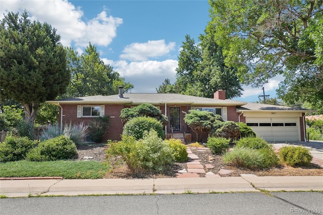 6920 W 47th Pl, Wheat Ridge, CO 80033 - single story home with brick siding, driveway, a garage, and a chimney