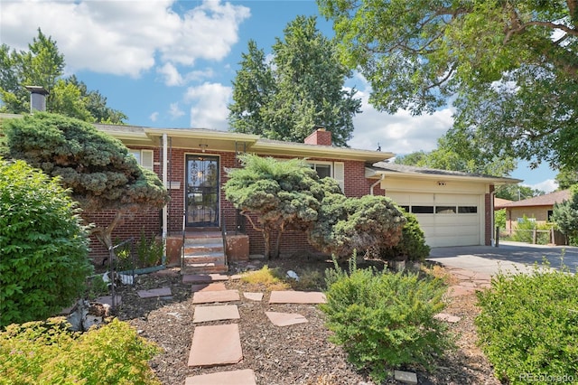 6920 W 47th Pl, Wheat Ridge, CO 80033 - single story home featuring concrete driveway, brick siding, an attached garage, and a chimney