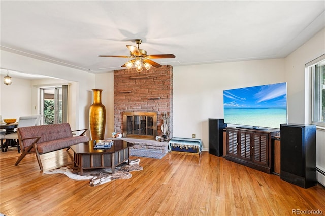 6920 W 47th Pl, Wheat Ridge, CO 80033 - living area featuring ceiling fan, plenty of natural light, wood finished floors, and a stone fireplace