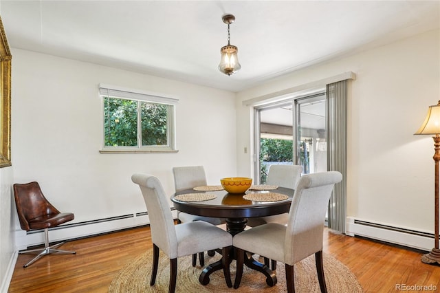 6920 W 47th Pl, Wheat Ridge, CO 80033 - dining room with healthy amount of natural light, a baseboard heating unit, and wood finished floors